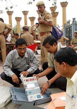 Officials check a voting machine in Guwahati on Sunday ahead of voting on Monday