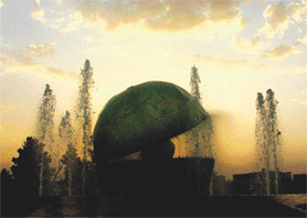 The fading sun in the evening’s cloudy sky gives the water coming out of the fountain installed on the YPS Chowk, Mohali, a coloured hue.