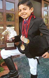 Eight-year-old Zorawar Singh Thiara poses with his medals and awards at his home in Chandigarh