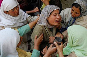 Relatives of Congress councillor Wali Mohammad War, who was killed by militants, wail over his death at his residence at Baramula on Tuesday