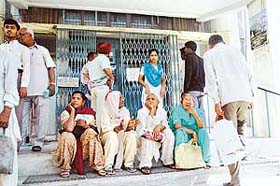 SBI customers wait outside Civil Lines branch of the bank, which remained closed for the second day on account of an indefinite strike called by its employees all over