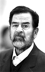 Former Iraqi President Saddam Hussein reacts during cross-examination at his trial in Baghdad's Green Zone on Wednesday