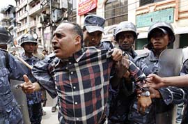 The Nepalese police arrests a demonstrator at Ason in Kathmandu