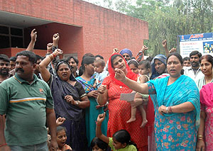 Residents of the DMC Colony protest outside the government dispensary against the non-availability of ORS packets on Saturday.