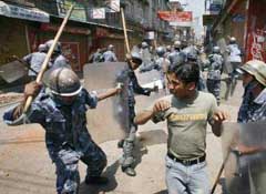 The Nepali police charges at a demonstrator shouting anti-monarch slogans, on the third day of a general strike called by Nepals seven main political parties, at Gongobhu in Kathmandu 