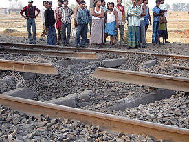 People stand near the site where Maoists blew up railway tracks at Banshilal halt in Gaya district on Sunday