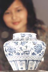 A visitor looks at a Guan Yuan dynasty jar due for auction at the Sothebys spring sales in Hong Kong on Monday. The blue and white jar is expected to fetch between HK $8 and 10 million.