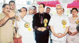 Mr Ramesh Joshi, Director, Punjab Pollution Control Board, lights the lamp to inaugurate an astrology camp in Ludhiana