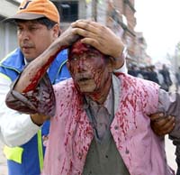 An injured demonstrator is taken away by a human rights activist after clashes with riot police during a demonstration in Gongabu in Kathmandu Valley