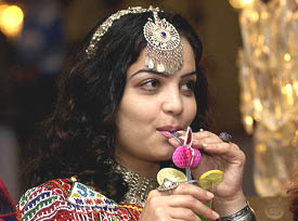 An Afghan girl, in a traditional attire, takes time off at the Afghan festival in New Delhi on Tuesday.