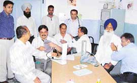 Specialists examine patients at a camp organised at Hind Hospital, Mandi Ahmedgarh, on Tuesday. 