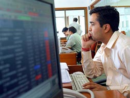 A stockbroker watches his computer screen in a brokerage company at the Bombay Stock Exchange on Wednesday.