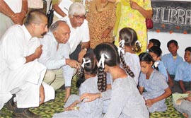 The Finance and Planning Minister, Mr Surinder Singla, and the Vice-Chairman, Bharti Enterprises, Mr Rakesh Bharti Mittal, interact with students of Government Primary School, Ramgarh, on Wednesday.