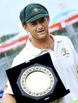 Australias Adam Gilchrist holds the man-of-the-match trophy at the end of the first Test against Bangladesh in Fatullah 