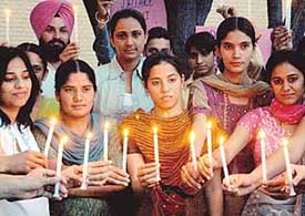 UGC-NET aspirants hold a candle light protest at the Gandhi Samarak Bhavan, Sector-16, Chandigarh, on Friday. 