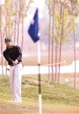 Indias Rahil Gangjee plays a chip shot on the second day of the Volvo China Open at the Beijing Honghua International Golf Club on Friday