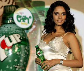 Actress Mallika Sherawat poses as she launches a 7UP Curvy bottle in Mumbai