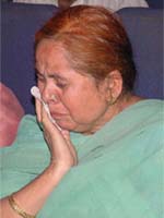A recipient fails to supress her tears as she receives compensation for the 1984 riots in Jalandhar