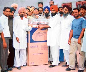 The winner of the pigeon flying competition receives prize at a function at Rasulpur village in Ludhiana on Saturday