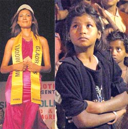 A slum girl pensively watches a super model on a giant screen at Panchkula during a fashion show
