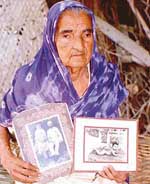 Ms Sarjit Kaur, an INA veteran, shows the photographs of her dead husband and son.