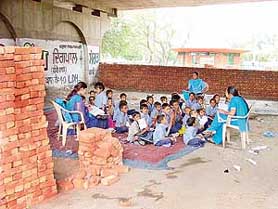A wall is raised under the flyover to cover a school in Ludhiana.