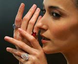 Hong Kong model Lisa Selesner displays a 5.34 carat oval-shaped blue diamond ring