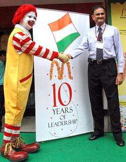 Managing Director McDonalds India (North) Vikram Bakshi poses at the unveiling of The 10th Year Logo in New Delhi on Thursday. McDonalds, which is celebrating 10 years of its operations in India this year, announced plans to expand into the eastern part of the country with Rs 400-crore investment. It would also be opening restaurants in Benaras, Amritsar, Patiala and Kolkata.  A Tribune photograph 