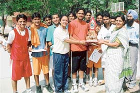 The winners receive trophy from the GNPS principal, Ms Jasminder S. Singh, on the final day of the First Inter-School Invitational Basketball Tournament
