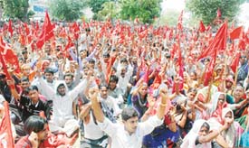 Industrial workers stage a dharna at Chhatar Singh Park in Ludhiana on Thursday