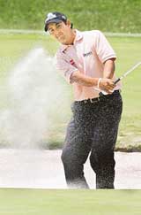Shiv Kapur plays a shot from a sand bunker during the first round of the BMW Asian Open Golf Championship in Shanghai