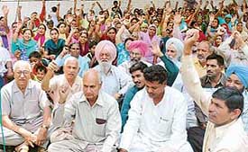Members of various political parties stage a dharna at the road separating Sectors 7 and 8 in Chandigarh