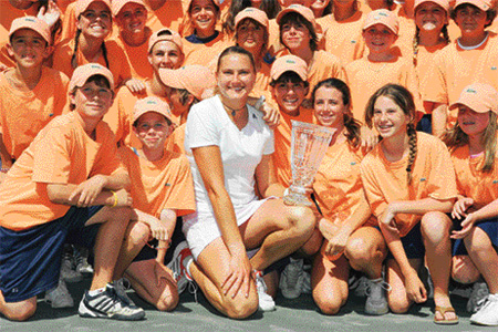 Russias Nadia Petrova poses with ballkids after beating Switzerlands Patty Schnyder in the final of the Family Circle Cup Tennis Tournament in South Carolina