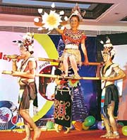 Malaysian dancers perform a traditional dance to promote Malaysia as a preferred tourist destination