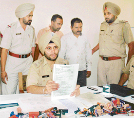 SSP AS Rai showing the fake C-forms used by the two accused, seen in the background, in the sale-purchase of 300 cars for evading sales tax worth crores of rupees.