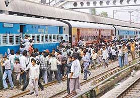 Candidates from different parts of the country, who came to appear for the railway test, rush to board a train at Chandigarh Railway Station on Sunday.