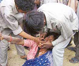 A distraught woman being consoled by relatives after the incident.