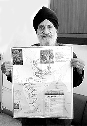 Giani Gurcharan Singh shows a map of the travel route taken by Lord Rama