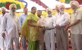 A student receives a prize at the annual prize distribution function at Government Senior Secondary School, Nathumajra village