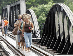 Tourists walk on Thailand's Death Railway at Kanchanaburi War Cemetery in Kanchanaburi province, 110 km west of Bangkok, on Monday.