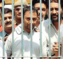 Sher Singh Rana (centre), the alleged killer of Phoolan Devi, is surrounded by Delhi policemen at a media briefing in New Delhi on Tuesday.
