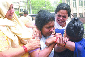 The mother of a schoolgirl, Dimpy, who committed suicide at Father Agnels School in South Delhi, being consoled by her relatives