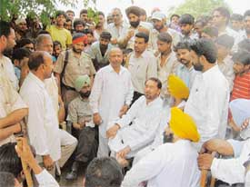 Wg Cdr Paramji Singh Sibia (retd), Chairman of the Ludhiana Improvement Trust, listens to their grievances in Ludhiana on Wednesday