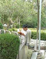 A student finds the environs of Punjabi Bhavan conducive for his studies for forthcoming examinations. He is engrossed in his studies oblivious of anything else