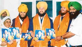 Three American Sikhs being honoured by Prof Davinder Singh Chhina with portraits of Sahibzadas