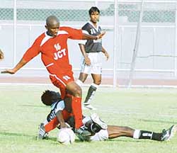 JCT striker Marcos Pereira tries to get past Gley Yao Rodrigue of Mohammedan Sporting in a National Football League match at Ludhianas Guru Nanak Stadium on Thursday