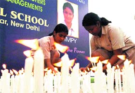 Students of Father Agnels School hold a candle light vigil in front of a portrait of their deceased schoolmate Dimpy who committed suicide, at a function
