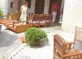 Anwari stares at her belongings thrown out of her room by henchman of a financier