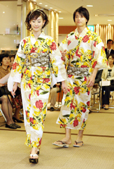 Models show off "yukatas", casual cotton kimonos for the summer season, with motifs of orchids and dragons at a kimono fashion show for summer shoppers at a departmental store in Tokyo on Sunday.