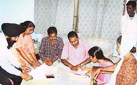 Punjab State Electricity Board officials collect applications from domestic consumers from the Scheduled Castes category for exemption of power bills at Mandi Ahmedgarh